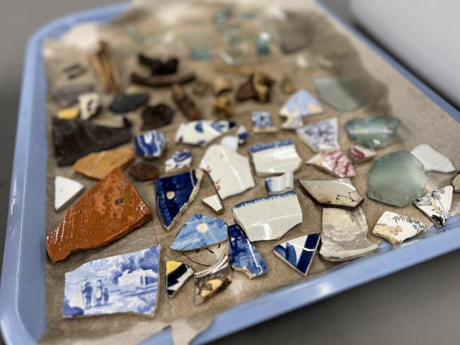 Sample of historic ceramics on a tray drying after being washed